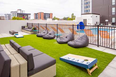 amenity outdoor patio seating game space of Seven07 U of I Student Living Development in Illinois