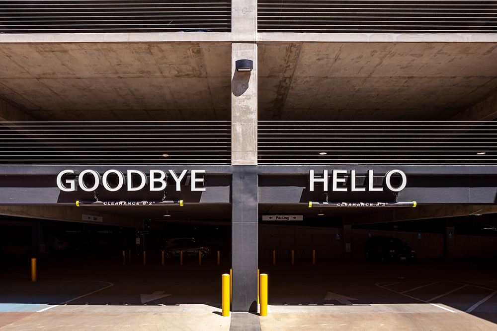entrance and exit of a parking garage with the exit on the left marked with the word goodbye and the entrance on the right marked with the word hello