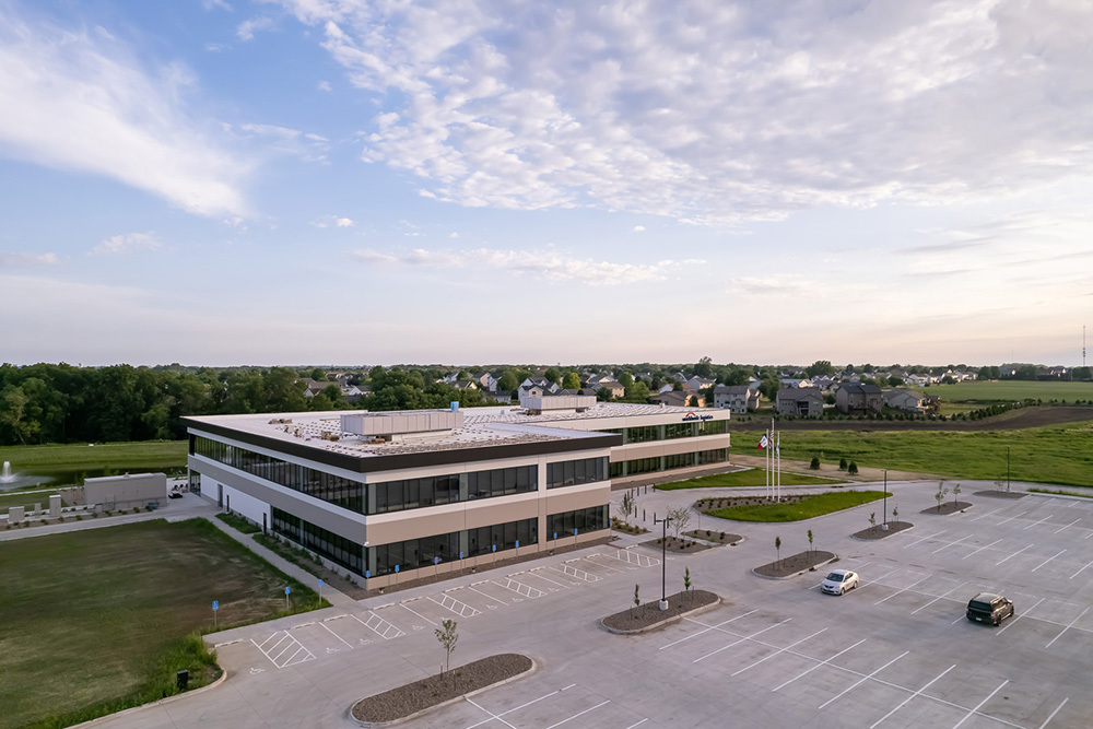 aerial view of office building with parking lot in foreground