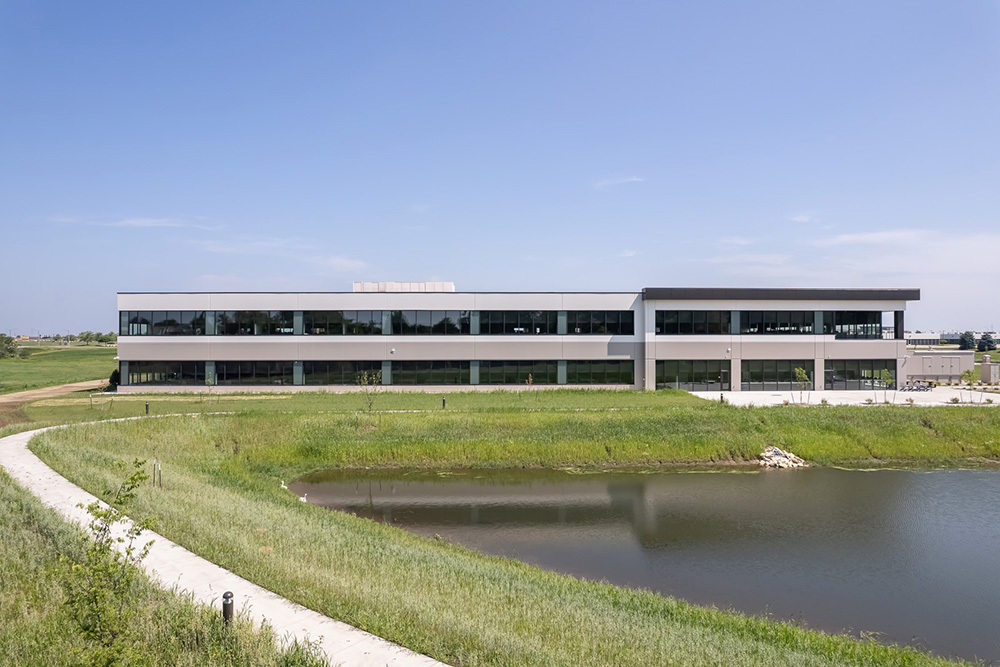 Exterior of office building with pond in foreground
